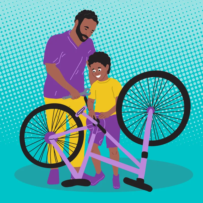 Deux personnes, un adulte et un enfant, en train de réparer un vélo renversé. L'adulte tient une clé à molette.